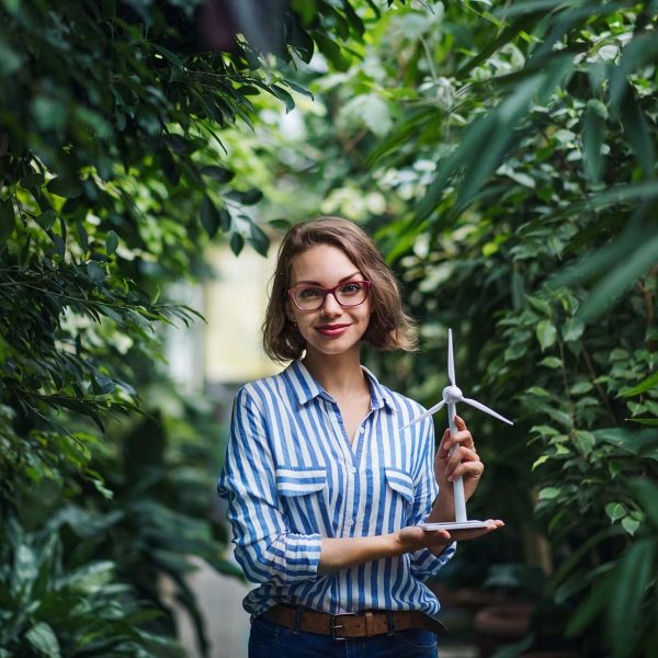 young-woman-with-windmill-model-standing-in-botani-U88JWDY.jpg
